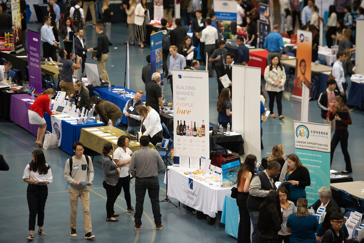 students and recruiters at the career fair in the gym