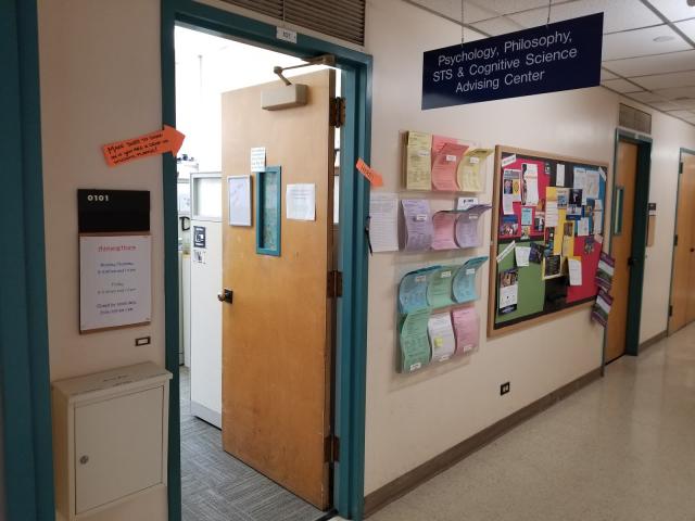 paper handouts placed outside of the door to advising office in young hall