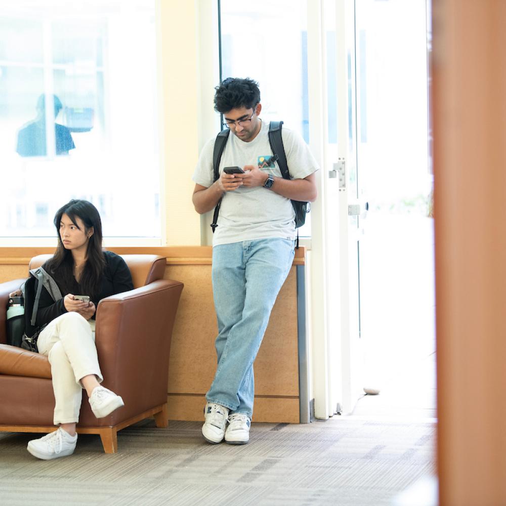 Two people waiting in a lobby