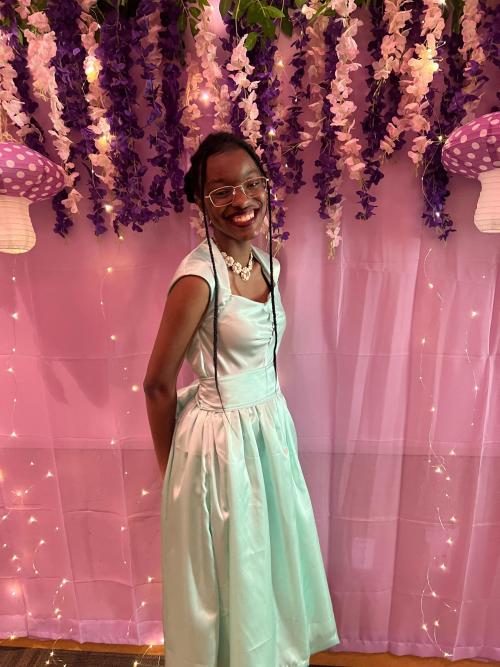 A girl in a dress smiling
