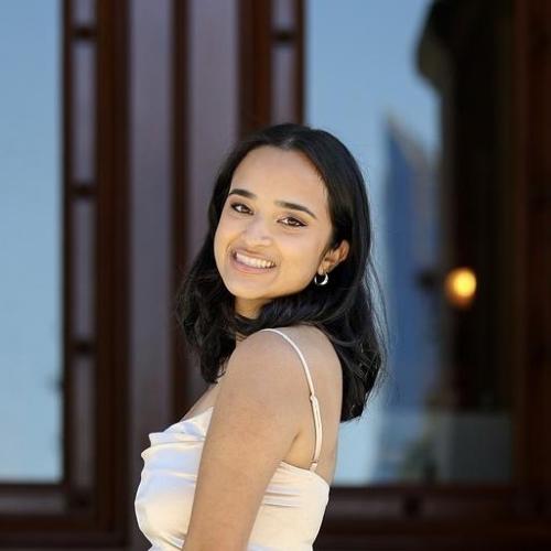 A girl in a dress smiling