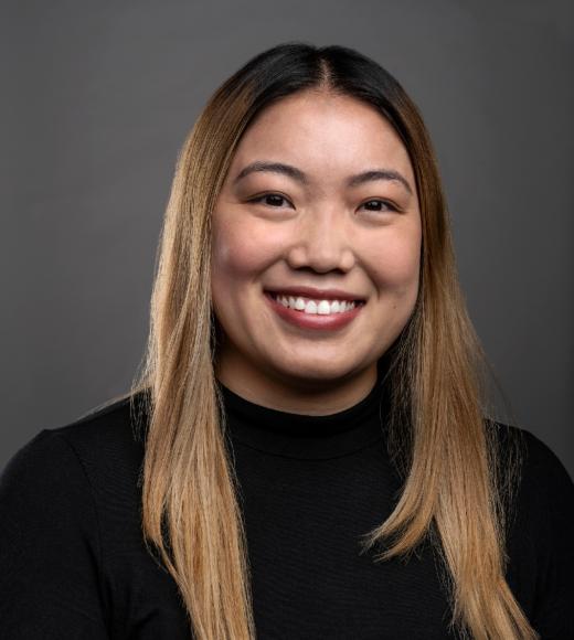 young asian woman with light brown hair and a black sweater