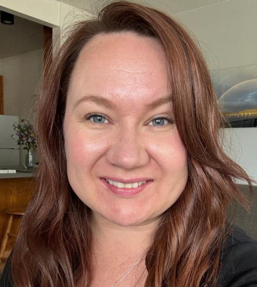 A woman with red hair smiling