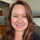A woman with red hair smiling