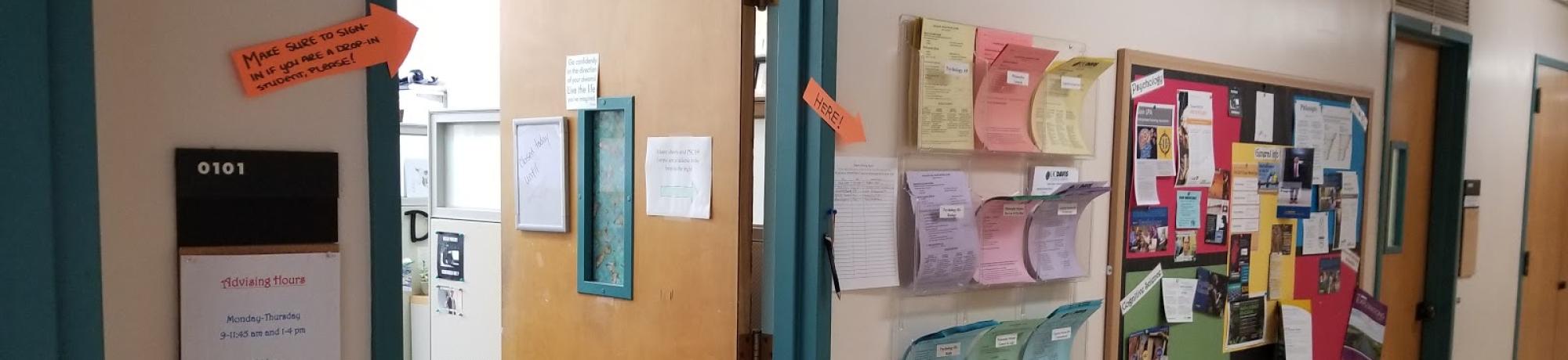 paper handouts placed outside of the door to advising office in young hall